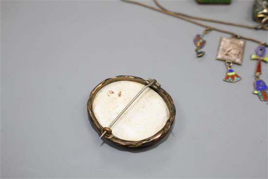 A white metal and enamel locket, a gilt metal and enamel necklace, two pendants, a brooch and 830 bug brooch, locket 24mm.